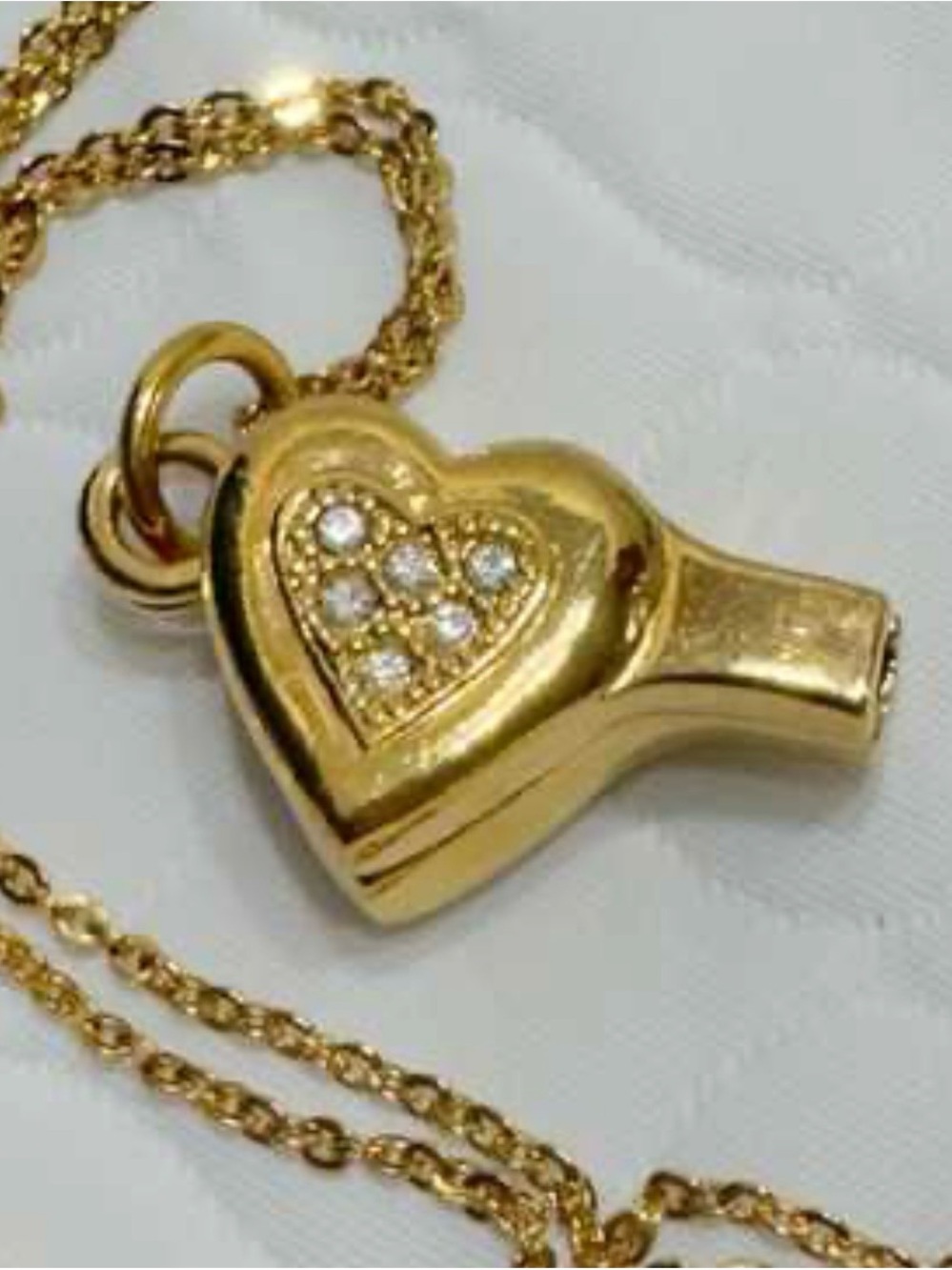 Vintage gold-toned Avon rhinestone heart whistle pendant necklace